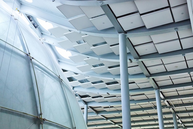 Exterior view of dome with white pillars and unique ceiling tiles in Academy of Sciences