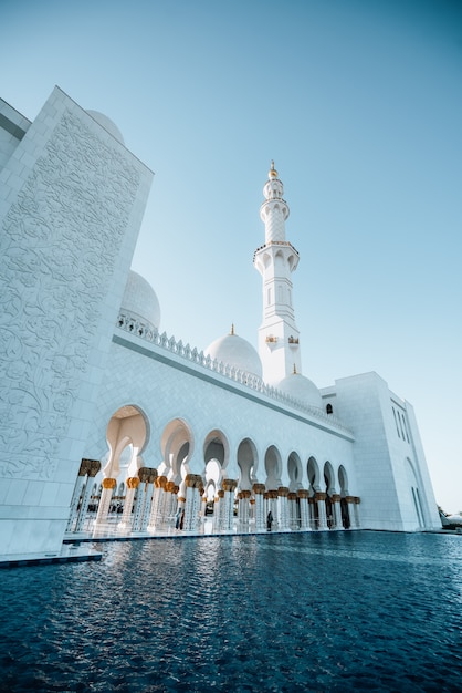 Foto vista esterna dell'enorme moschea bianca con alta torre bianca