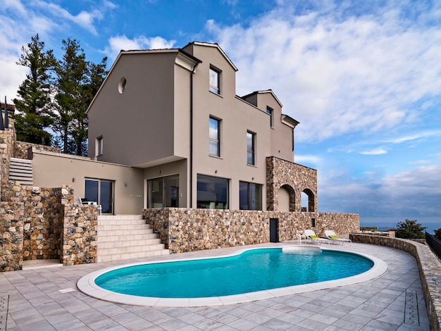 Exteriors view of a modern villa in the foreground the swimmingpool