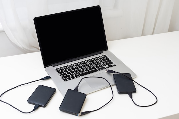 Photo external backup disk hard drive connected to laptop. high quality photo