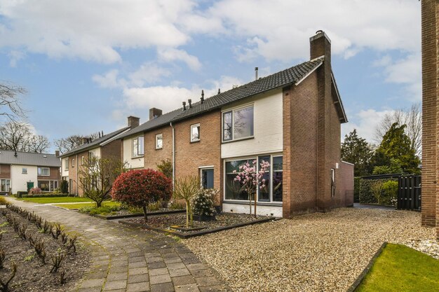 External view of a house with a driveway and garden