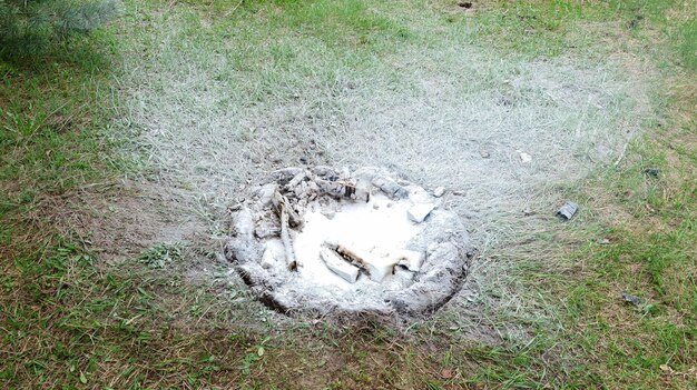 Extinguished campfire in a clearing in the forest close-up.