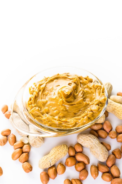 Extra chunky peanut butter on a white background.