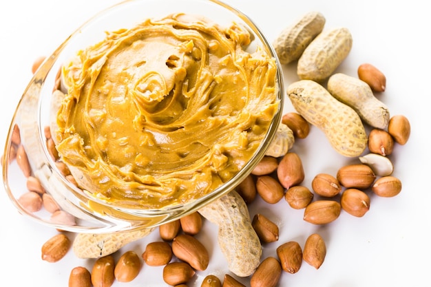 Extra chunky peanut butter on a white background.