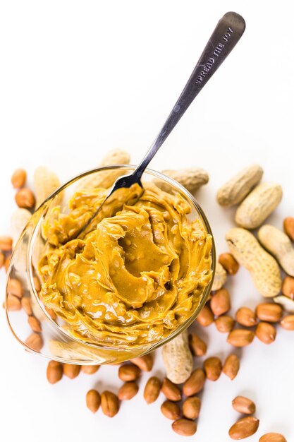 Extra chunky peanut butter on a white background.