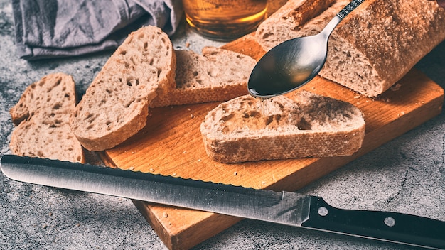 Extra virgin olive oil on a slice of natural homemade bread Traditional Mediterranean breakfast concept.