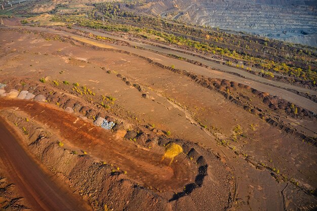 Extraction of minerals with the help of special equipment in the warm evening light in picturesque Ukraine. Aerial panoramic drone shot