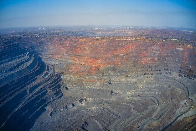 Extraction of minerals with the help of special equipment in the warm evening light in picturesque Ukraine. Aerial panoramic drone shot