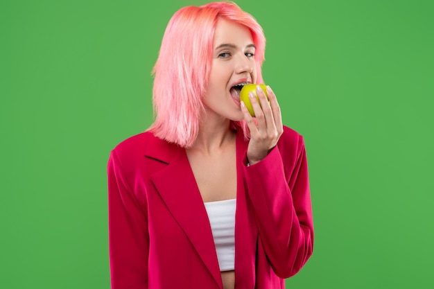 Photo extravagant young female eating healthy fresh fruit