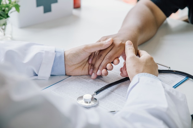 Extreme close-up of a doctor examining patient's hand in the medical office