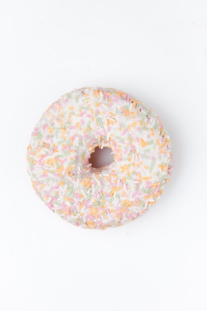 Extreme close up of a doughnut with multi coloured icing sugar