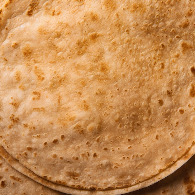 extreme closeup shot of one round warm tortilla topdown view