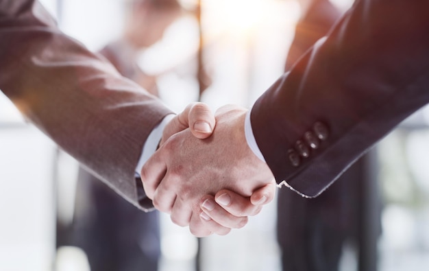 Extreme closeup of two men shaking hands