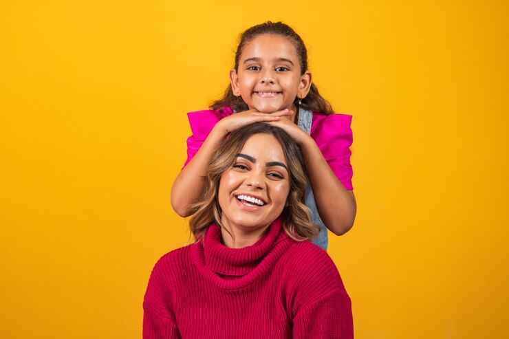 Extroverted sisters making poses and expressions on yellow background on brother's day. brother's day concept
