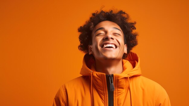 An exuberant young man isolated on an orange background radiating youthful energy showcasing moments of excitement