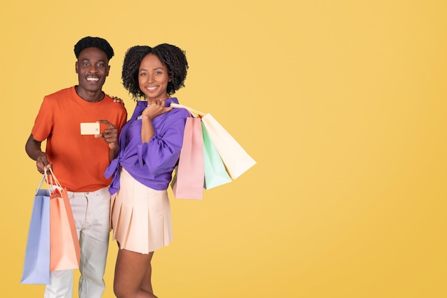 An exuberant young man in an orange shirt and a delighted young woman