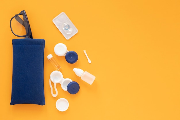 Eye care accessories on orange background