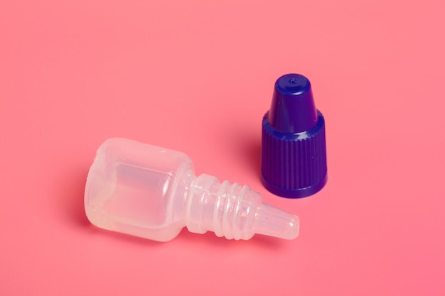 Eye drops isolated on pink 