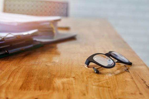 Eye glasses and documents on office desk