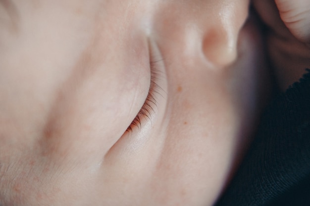 Eye of newborn baby close up.