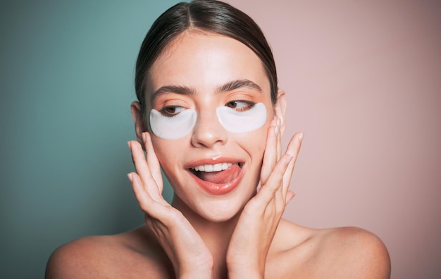 Under eye patches for dark circles and puffiness Taking care of her skin Pretty woman using eye patches spending time at home Daily pampering routine Modern cosmetics Eye patches concept