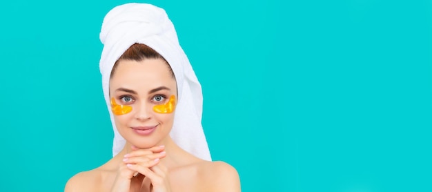 Eye patches patch under eyes positive young woman has collagen golden eye patches on face with towel