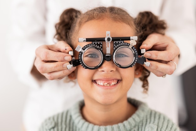 Eye vision and test with child for glasses in optometry office for eye care and health Eyewear exam and medical opthalmology with little girl testing for lenses and frames diagnosis for optics