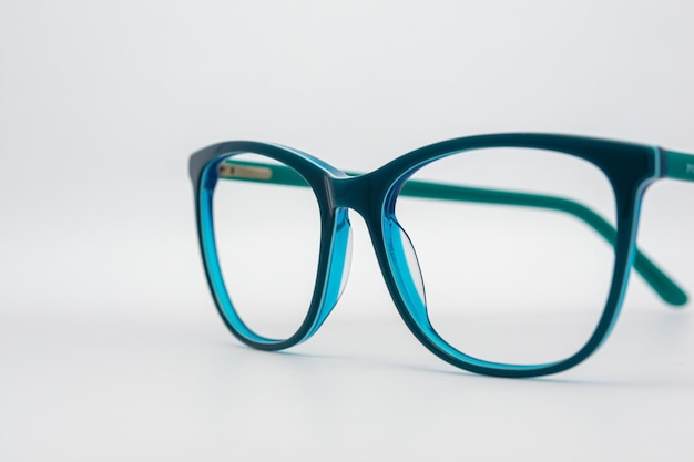 Eyeglass frames, lenses, various colors, both metal and plastic, on a beautiful colored background.