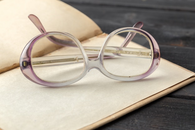 Eyeglasses and book on the table