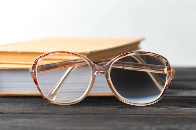 Eyeglasses and book on the table