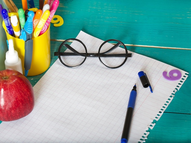 eyeglasses sheet of paper and a pen free space for a text