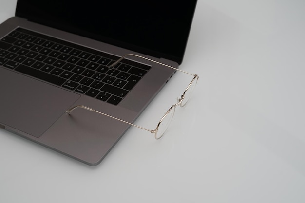 Eyeglasses on workspace and white background