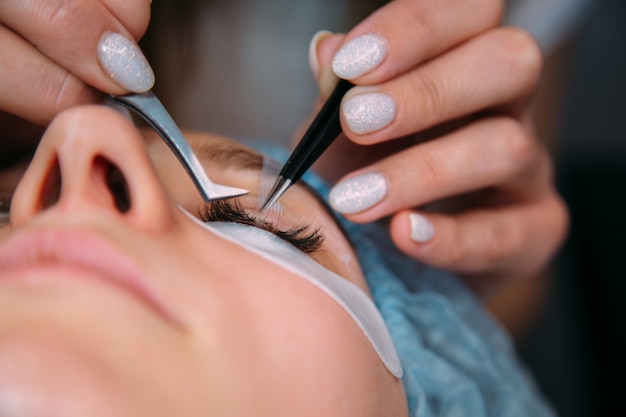 Eyelash extension procedure. woman eye with long eyelashes. lashes, close up, macro, selective focus.