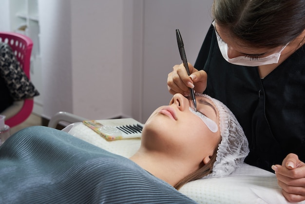 eyelash extension procedure woman eye with long eyelashes