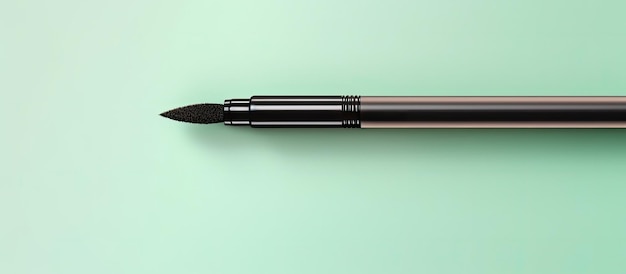 Eyeliners placed on a mint colored background with empty space available for text Viewed from