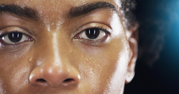 Photo eyes fitness and portrait of woman with sweat on dark background for workout exercise and training health wellness and face zoom of female person with dedication motivation and focus for sports