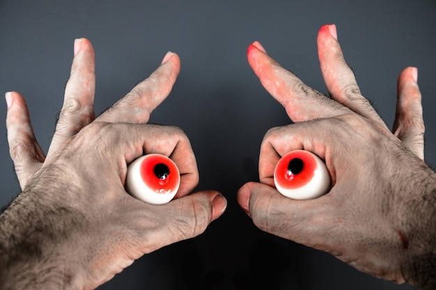 eyes on hands to look like a monster at halloween 2022