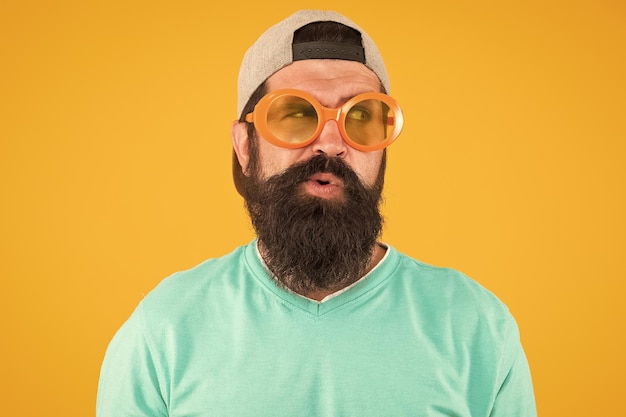 Eyes health eyesight check ups good vision fun and
entertainment funny accessory man eyewear model funny sunglasses
bearded man in sunglasses orange background hipster wear party
sunglasses