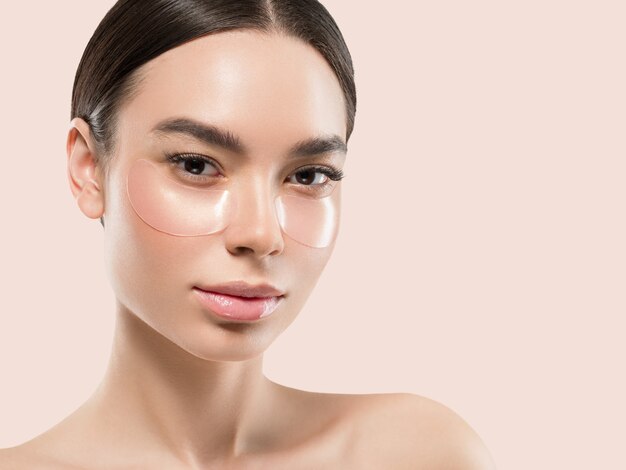 Eyes mask asian woman face cosmetic. Color background. Pink