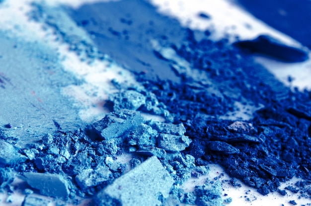 Eyeshadow cosmetic powder scattered. Color of the year 2020 Classic Blue. Copy Space.