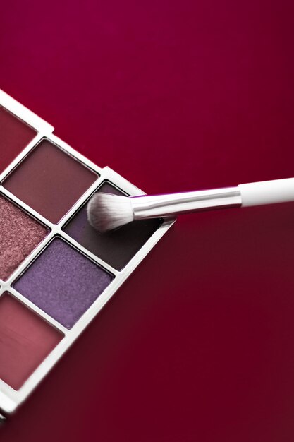 Eyeshadow palette and makeup brush on cherry background eye shadows cosmetics product for luxury beauty brand promotion and holiday fashion blog design