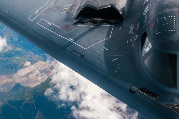 A f - 35 jet is flying over the clouds.