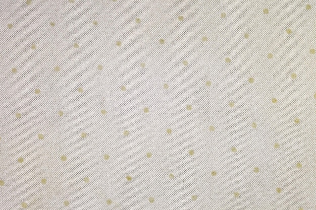 Fabric beige closeup with round dots woven surface background wallpaper uniform texture pattern