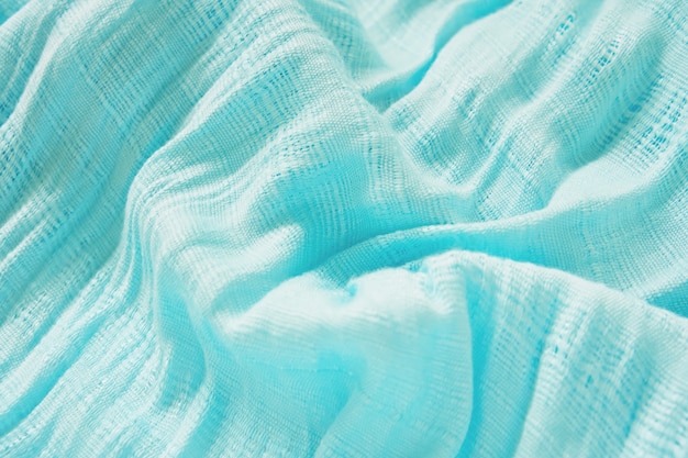 The fabric of the blue scarf. The show is a wave of light and shadow.