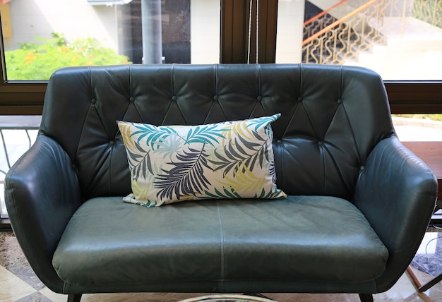 Photo fabric pillows on leather sofa