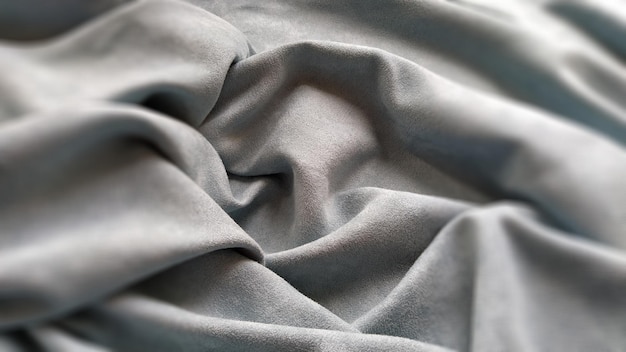 Fabric sheer curtain fabric Beautiful grayblue color Soft velvet with a pile The curtain material is carelessly folded and wrinkled on a horizontal surface Fabric sample Interior design option