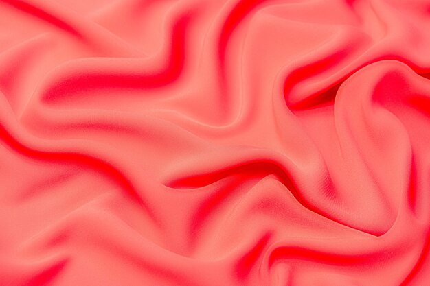 Fabric texture, background for design. Texture of red silk or cotton or wool fabric. Beautiful pattern of waven fabric.