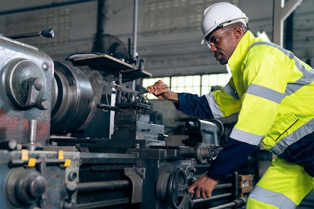 Fabrieksarbeider of ingenieur doet machinewerk in bedreven productiewerkplaats;