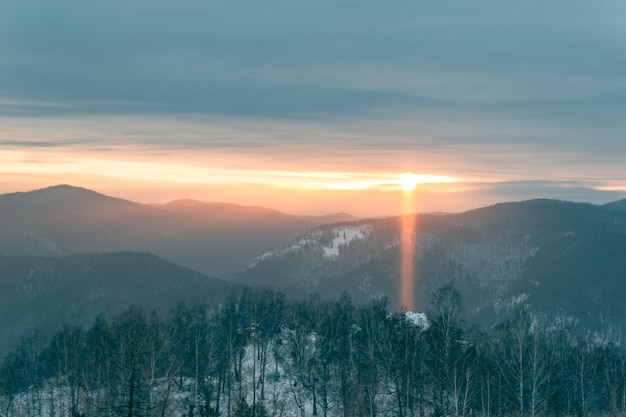 Fabulous panoramic view of the mountain valley at sunset. A ray of sun hitting the ground.