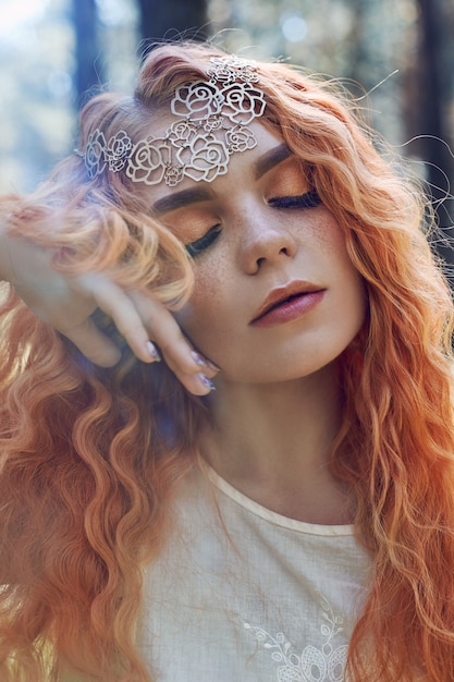 Fabulous portrait of a red-haired girl in nature